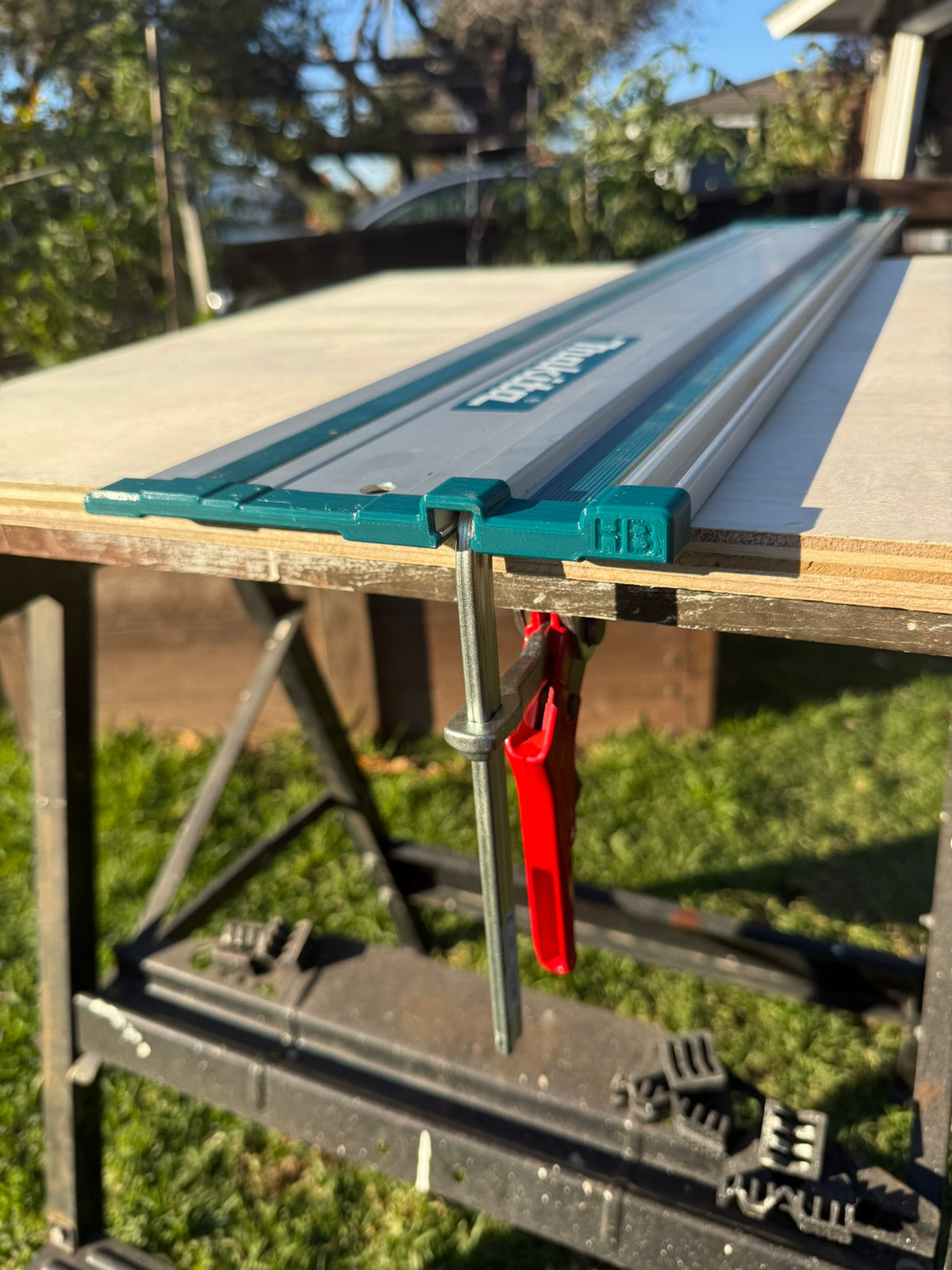 Makita guide rail end cap installed with a clamp inserted through the rail channel